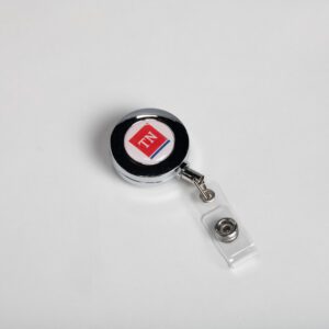 A red and white badge holder on top of a table.