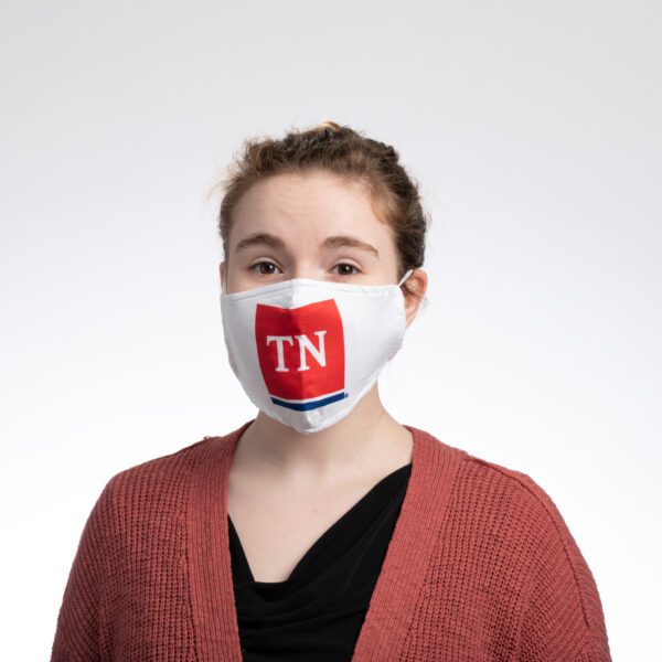 A woman wearing a face mask with the tennessee state logo.