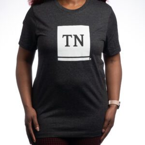 A woman wearing a black t-shirt with the letter tn on it.